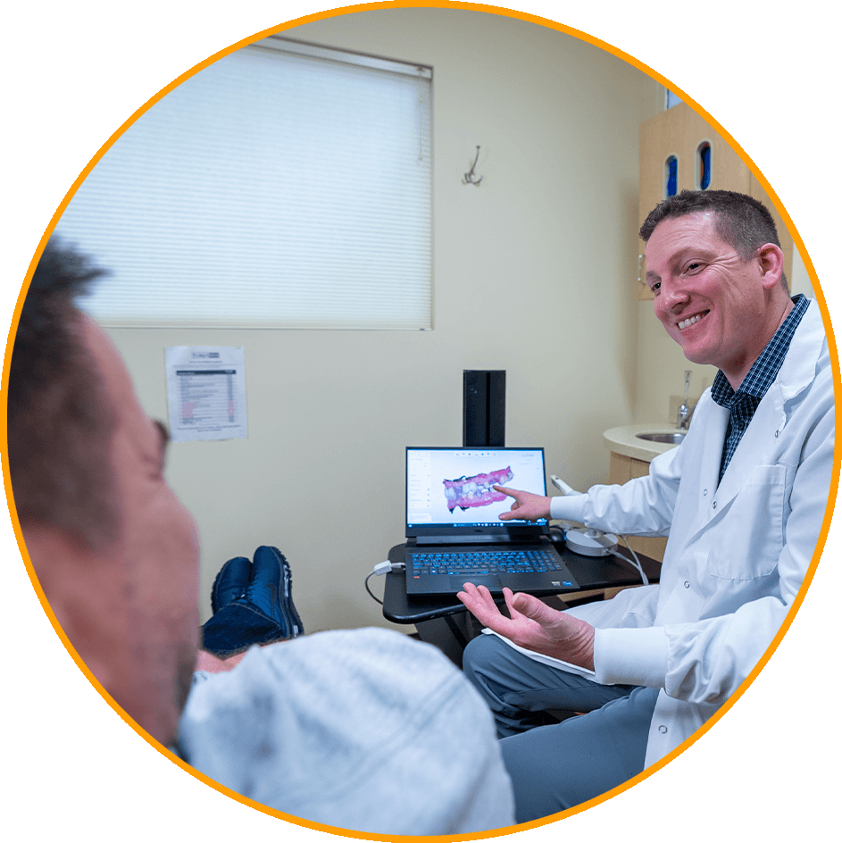 doctor going over 3d scan of patients teeth